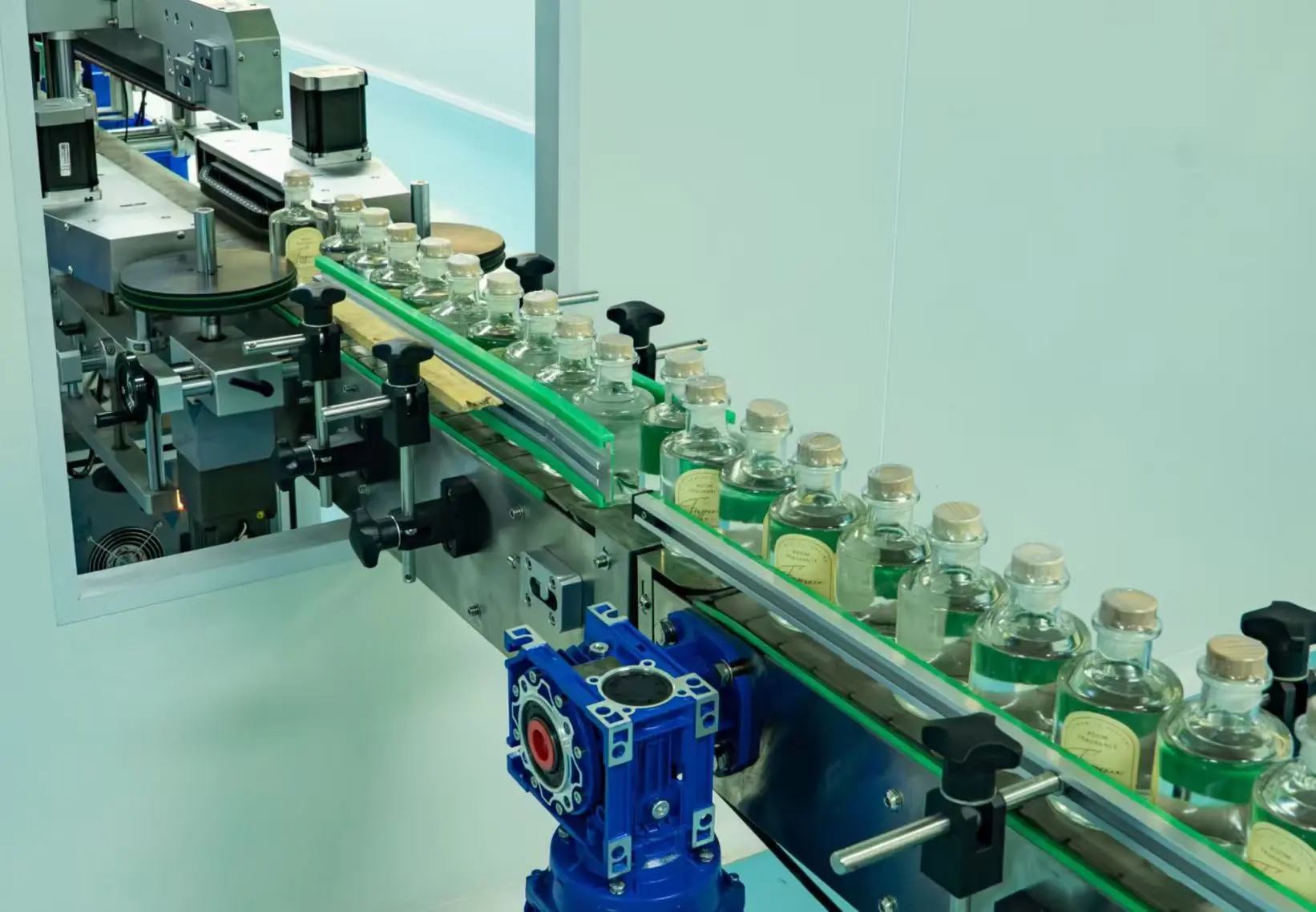 Reed diffuser bottles on a production and labeling line
