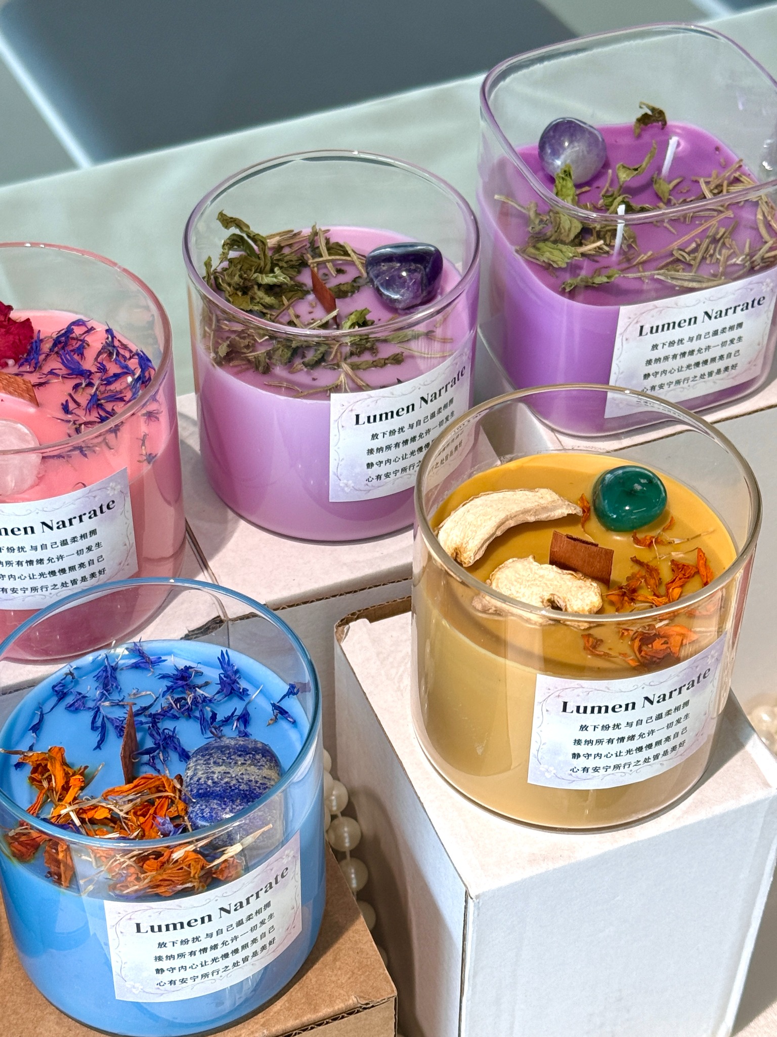 Therapeutic aroma candles arranged on boxes for wholesale and brand display